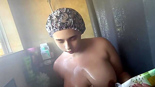 Chubby cutie gets wet and soapy in the shower